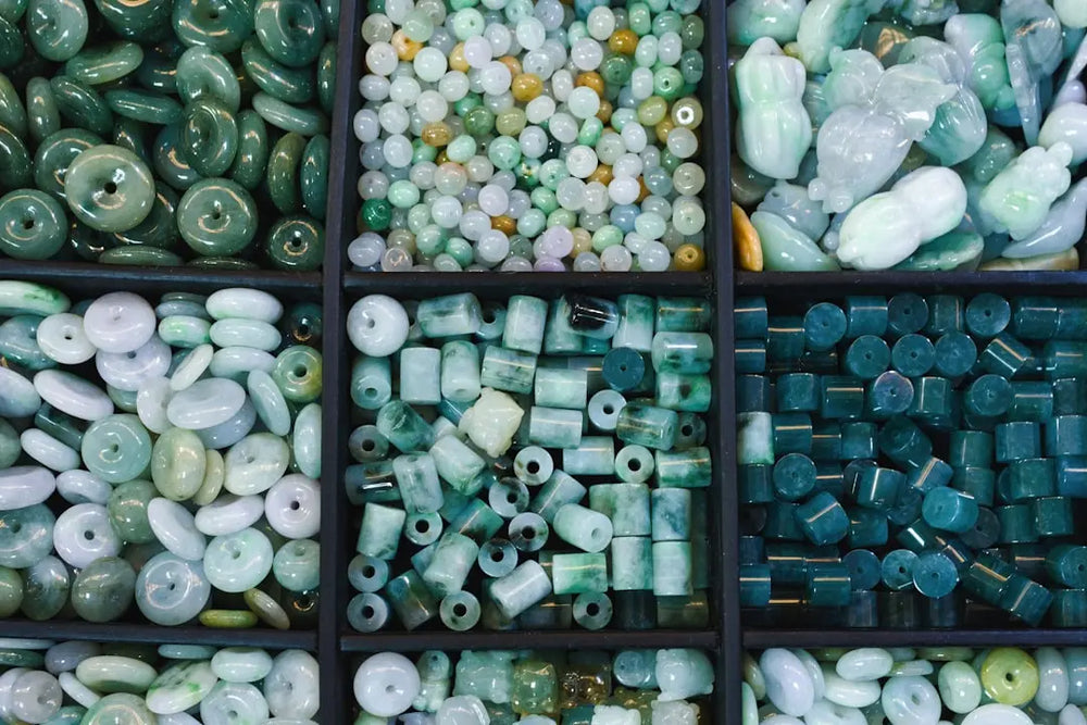 Assortment of green and white jade beads in compartments - Photo by Eric Prouzet on Unsplash