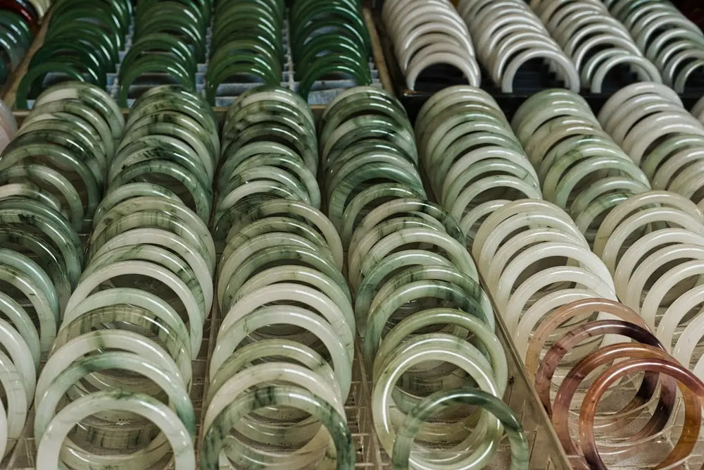 Rows of jade bracelets in various green and white shades - Photo by Eric Prouzet on Unsplash