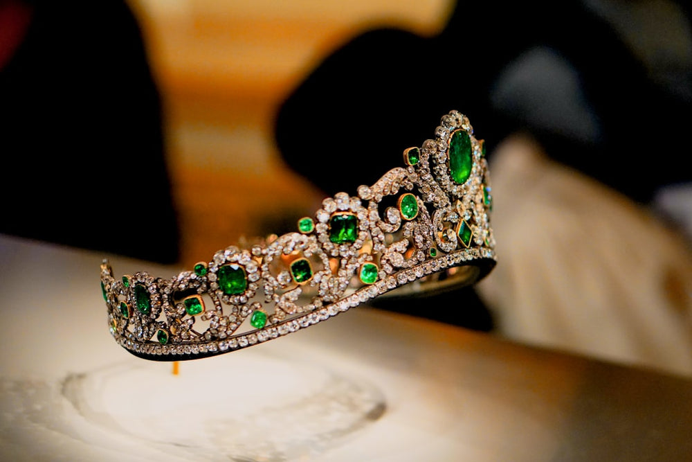 a tiara on a table with a person in the background - Photo by Khyta on Unsplash
