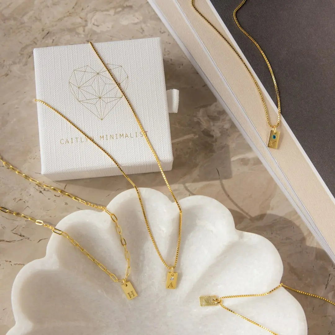 a set of three necklaces sitting next to a box - Photo by Natali Hordiiuk on Unsplash
