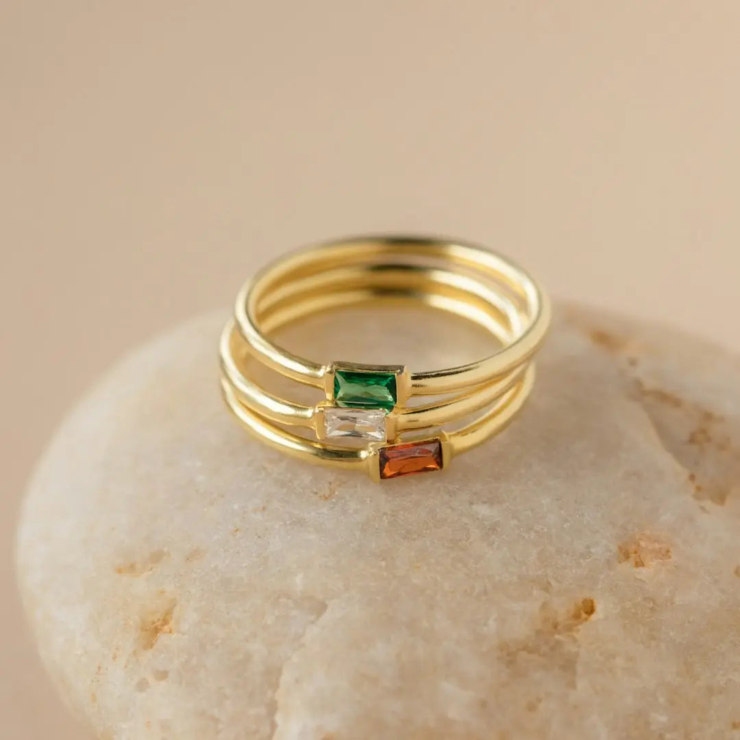 a stack of three rings sitting on top of a rock - Photo by Natali Hordiiuk on Unsplash