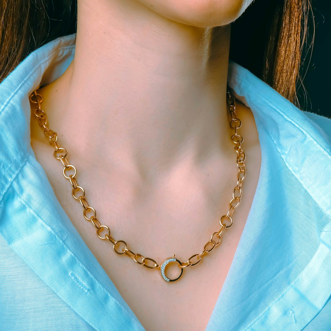 A close up of a woman wearing a necklace - Photo by NEXARO STUDIO on Unsplash