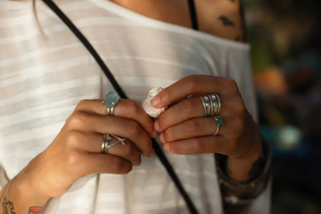a close up of a person holding two rings - Photo by Alexey Demidov on Unsplash