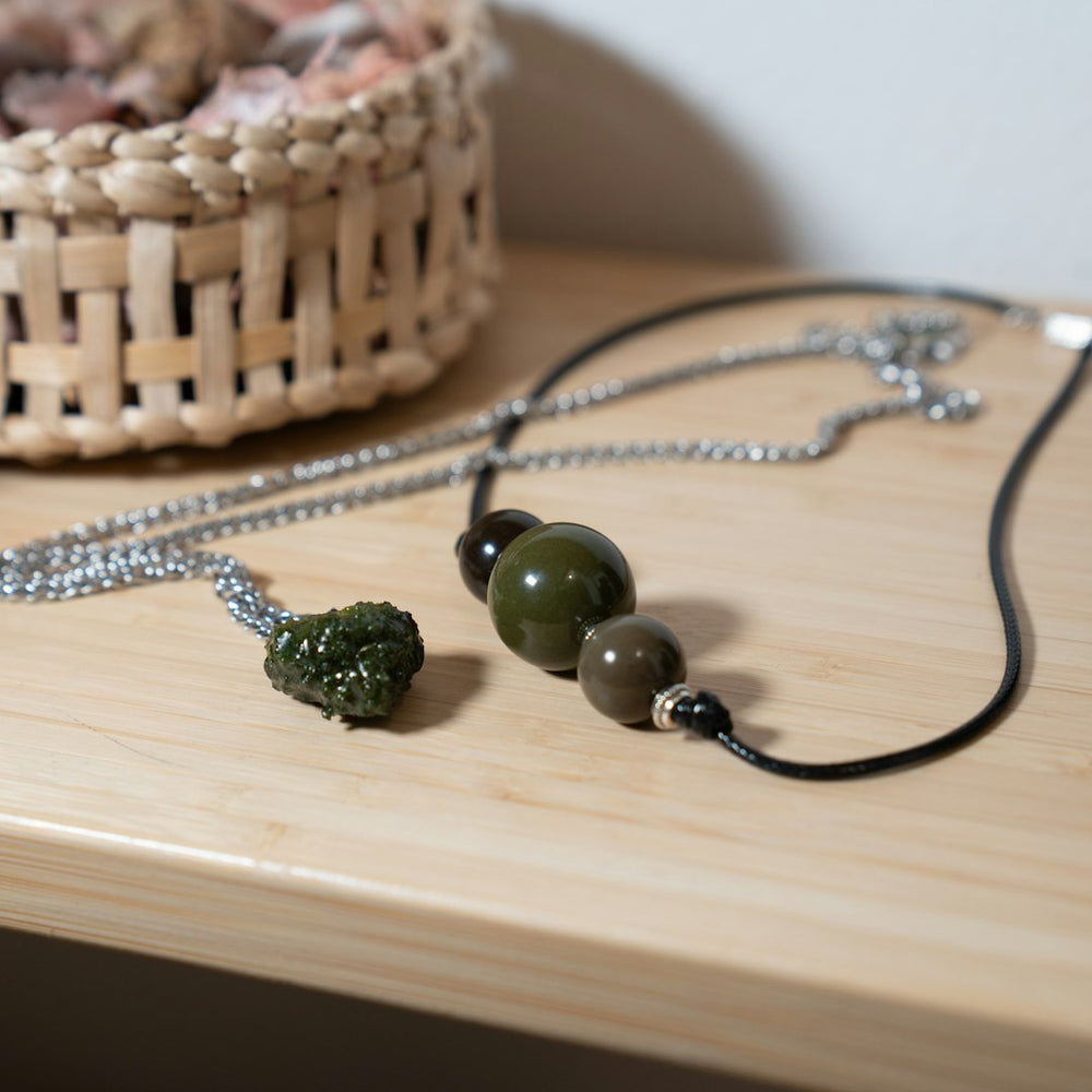 a close up of a necklace on a table - Photo by CRYSTALWEED cannabis on Unsplash