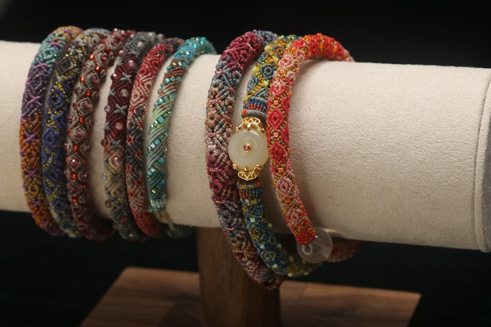 Colorful beaded bracelets displayed on a stand - Photo by hoylee song on Unsplash