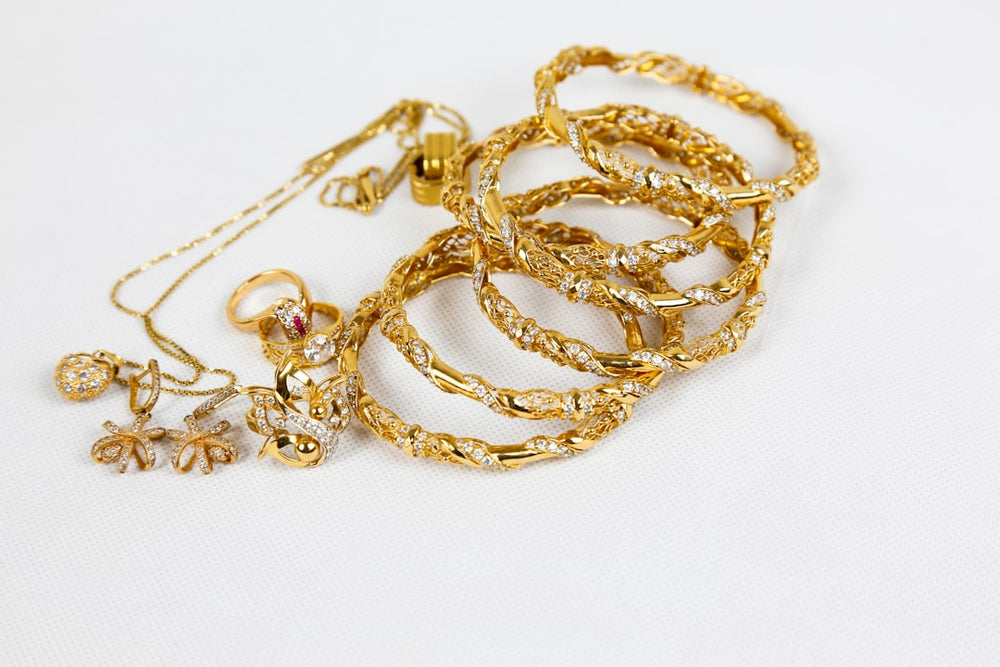 gold chain necklace on white surface - Photo by Syed F Hashemi on Unsplash