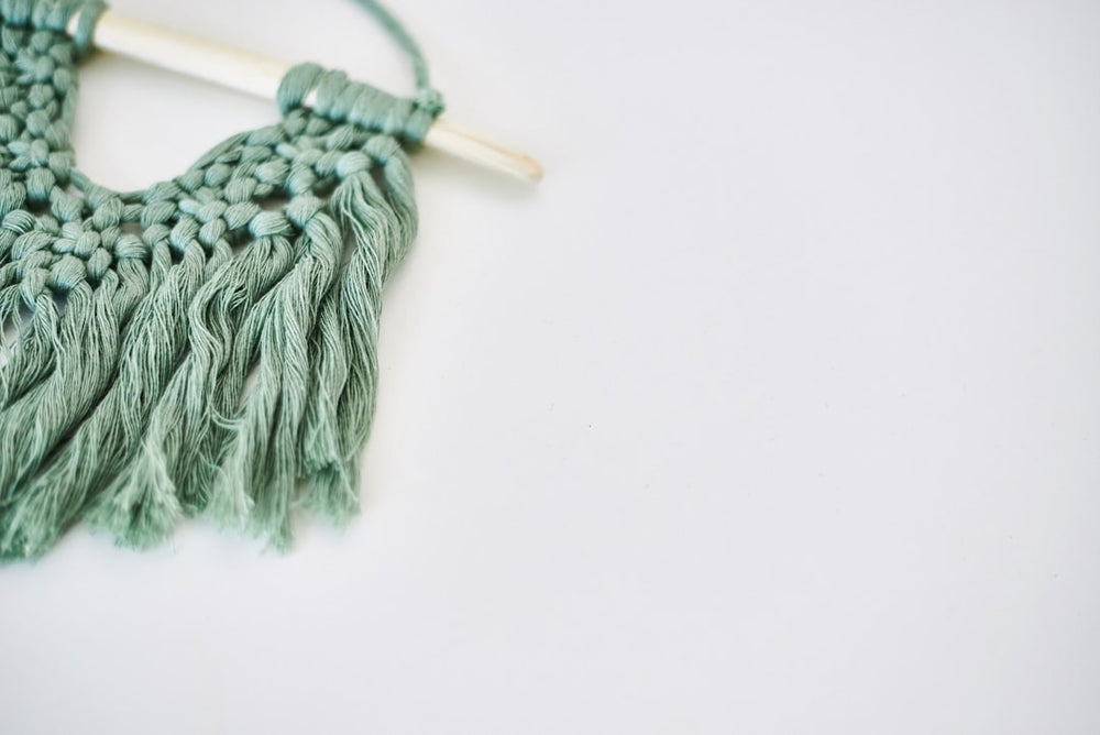 gray yarn on white surface - Photo by Elena Putina on Unsplash