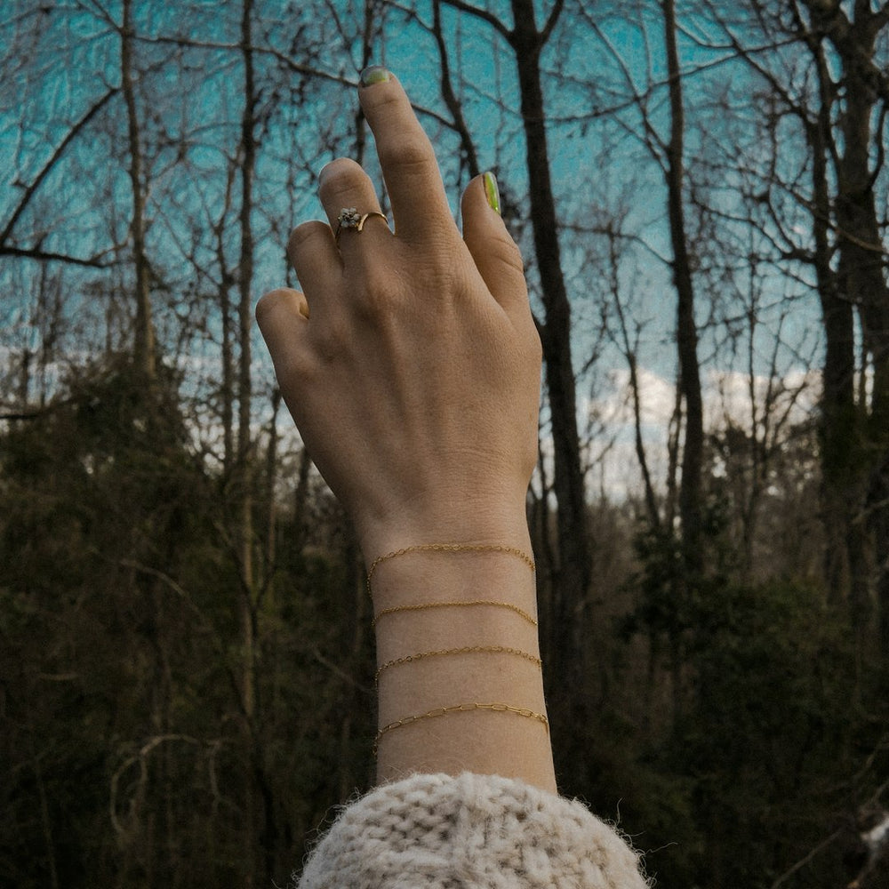 a woman's hand with a ring on it - Photo by katie ruocco on Unsplash