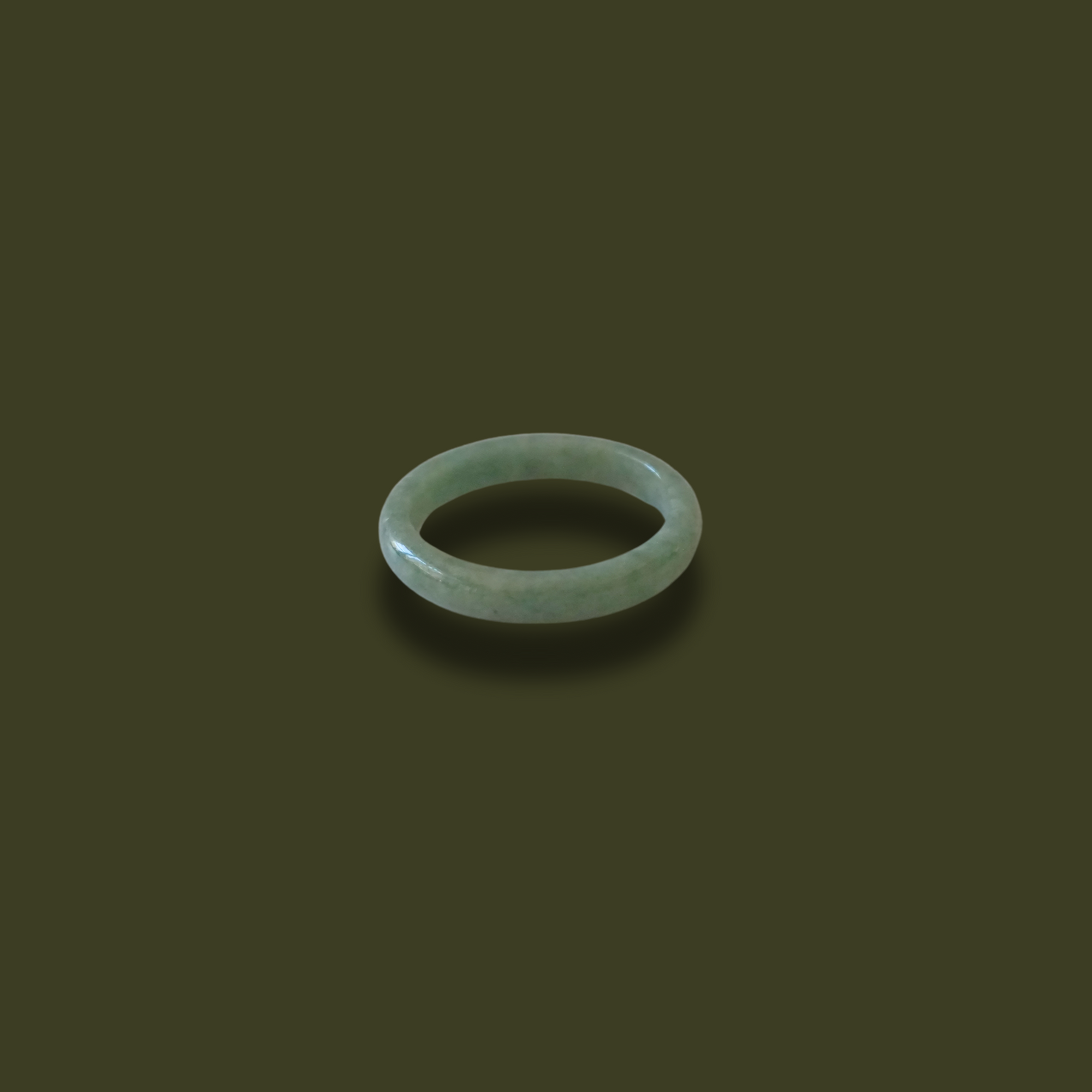 Minimalist solid jadeite ring with a smooth finish, hand-carved to highlight the natural beauty and symbolic meaning of purity, balance, and heritage.