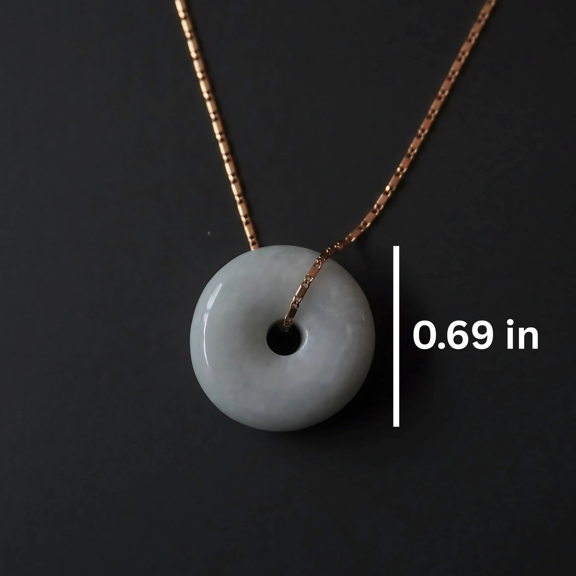 Elegant green jade pendant on fine gold box chain, symbolizing harmony and wholeness