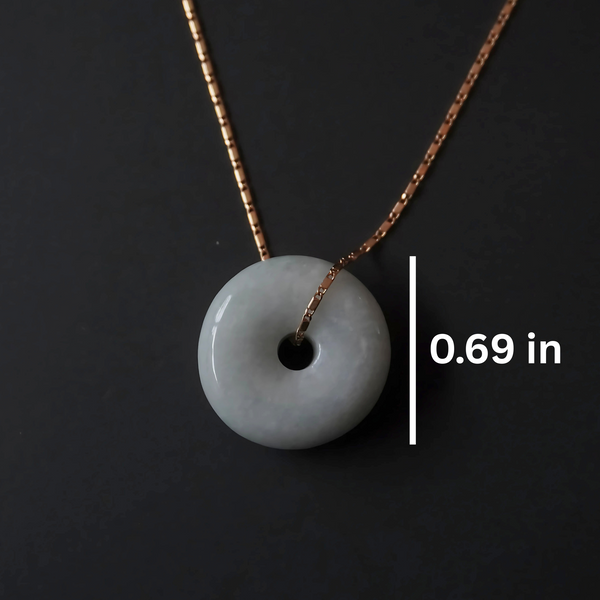 Elegant green jade pendant on fine gold box chain, symbolizing harmony and wholeness