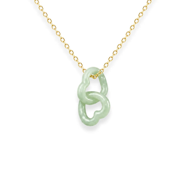 Necklace with a jade pendant on a gold chain against a white background