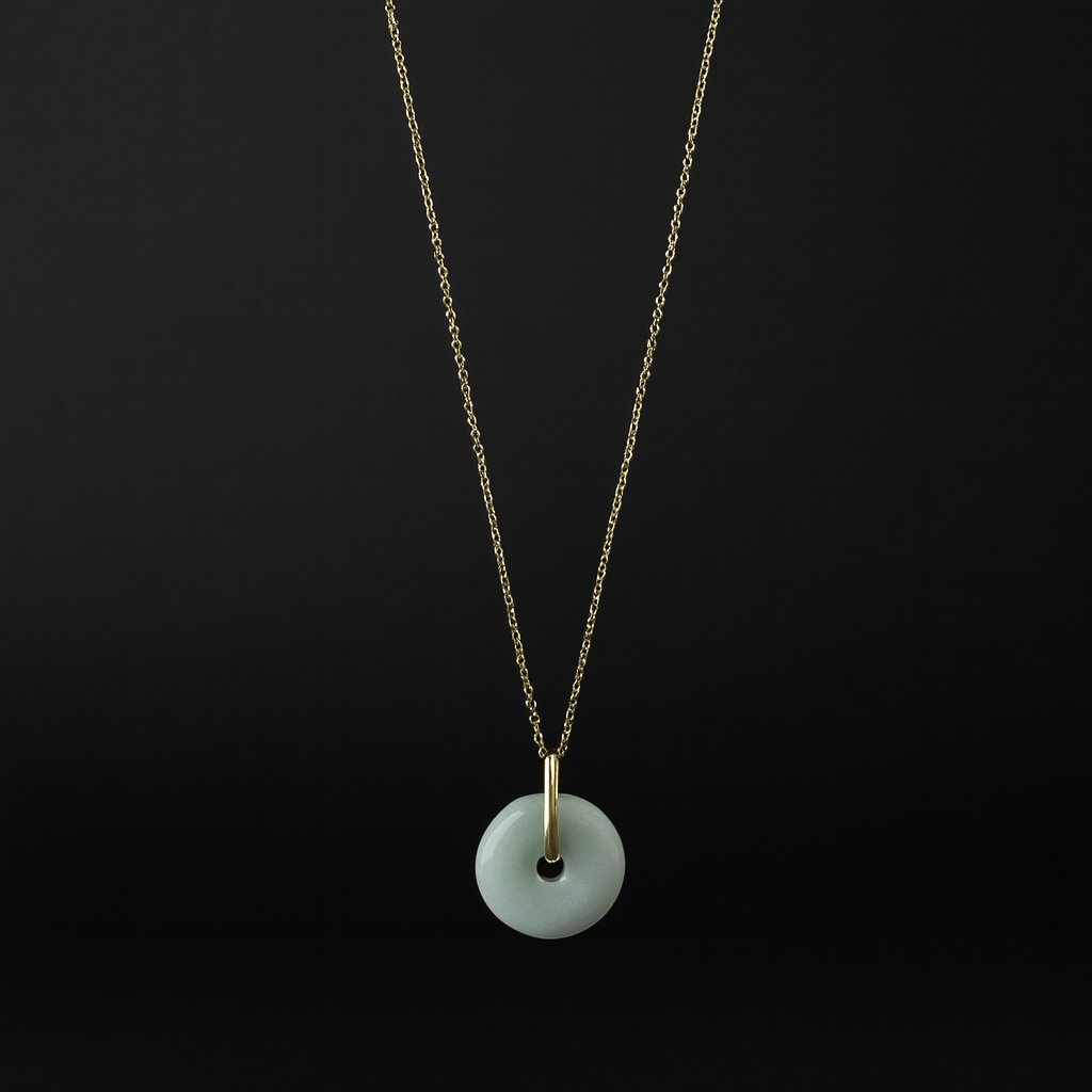 Necklace with a white pendant on a black background