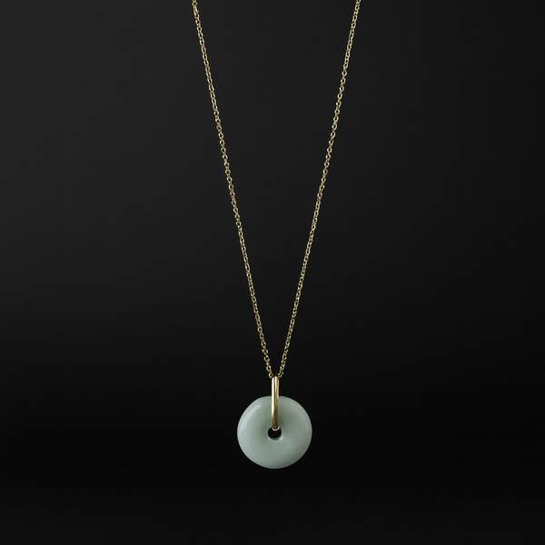 Necklace with a white pendant on a black background