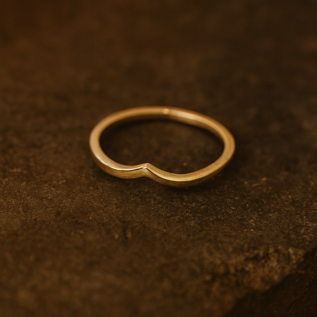 Gold ring on a textured brown surface