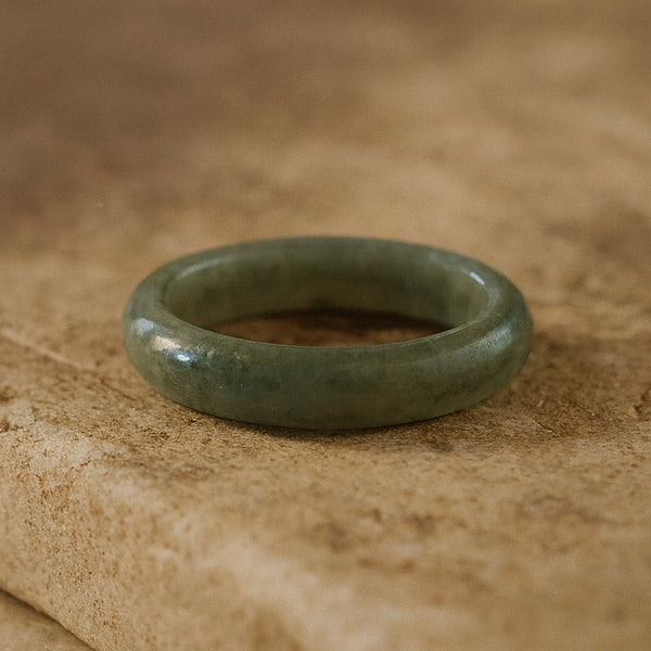 Side View of a Minimalist solid jadeite ring with a smooth finish, hand-carved to highlight the natural beauty and symbolic meaning of purity, balance, and heritage.