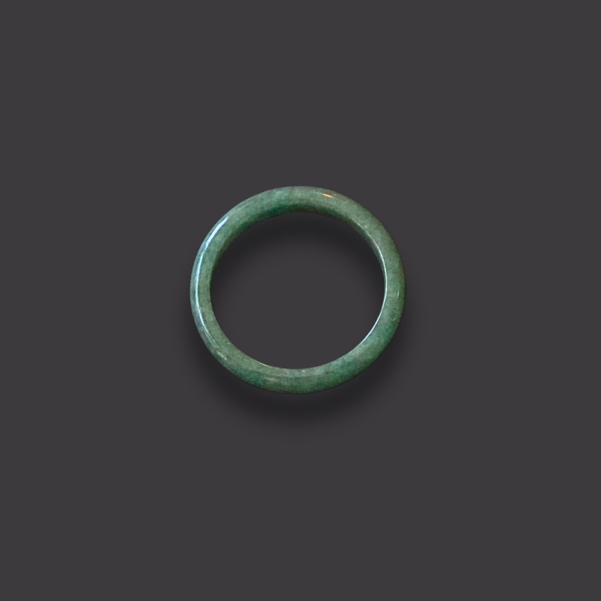 Minimalist solid jadeite ring with a smooth finish, hand-carved to highlight the natural beauty and symbolic meaning of purity, balance, and heritage.