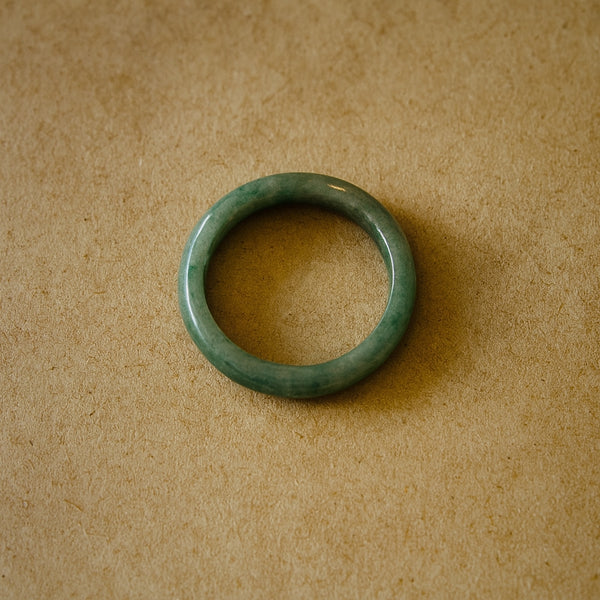 Minimalist solid jadeite ring with a smooth finish, hand-carved to highlight the natural beauty and symbolic meaning of purity, balance, and heritage.