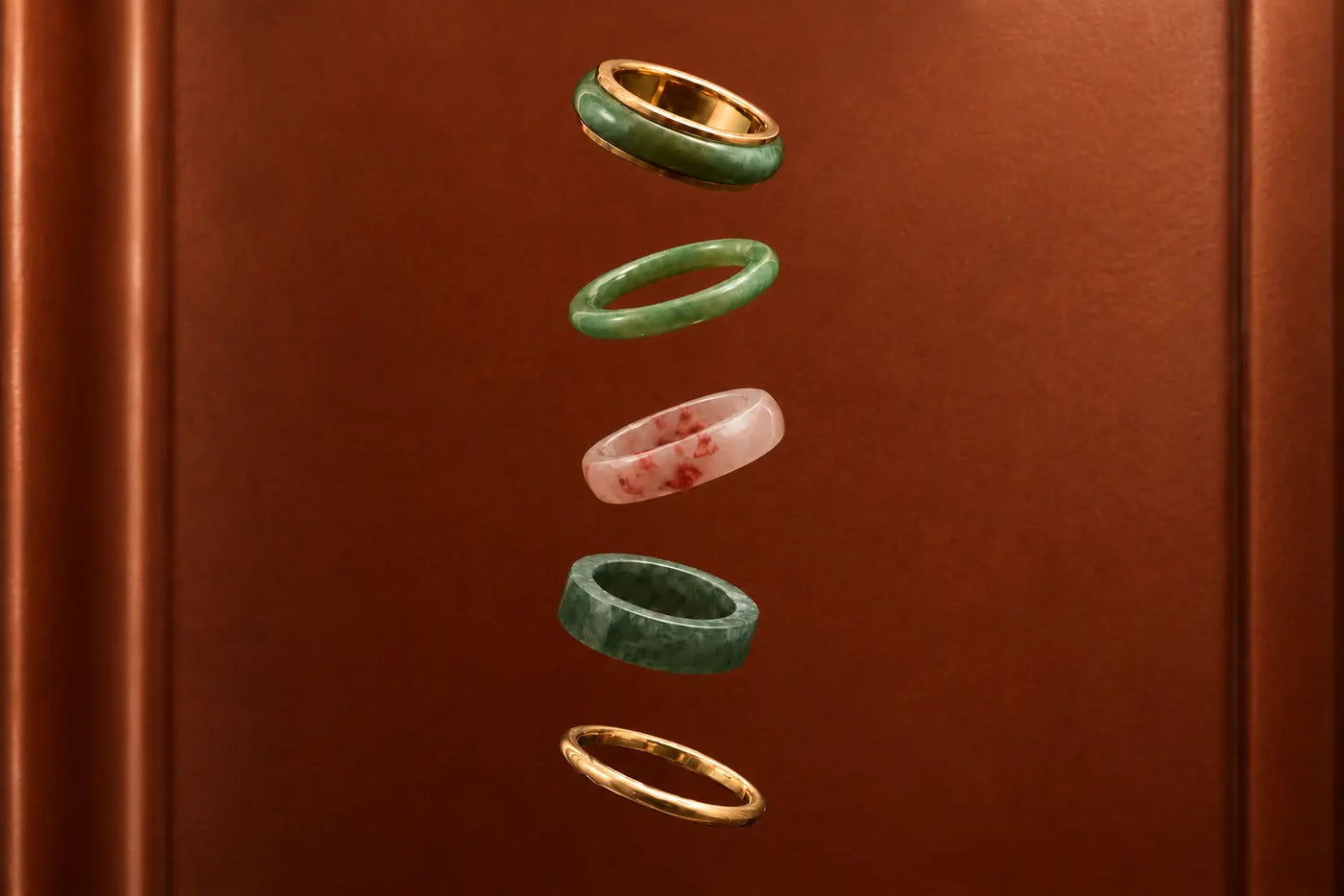 Jewelry rings with green and gold tones on a brown background