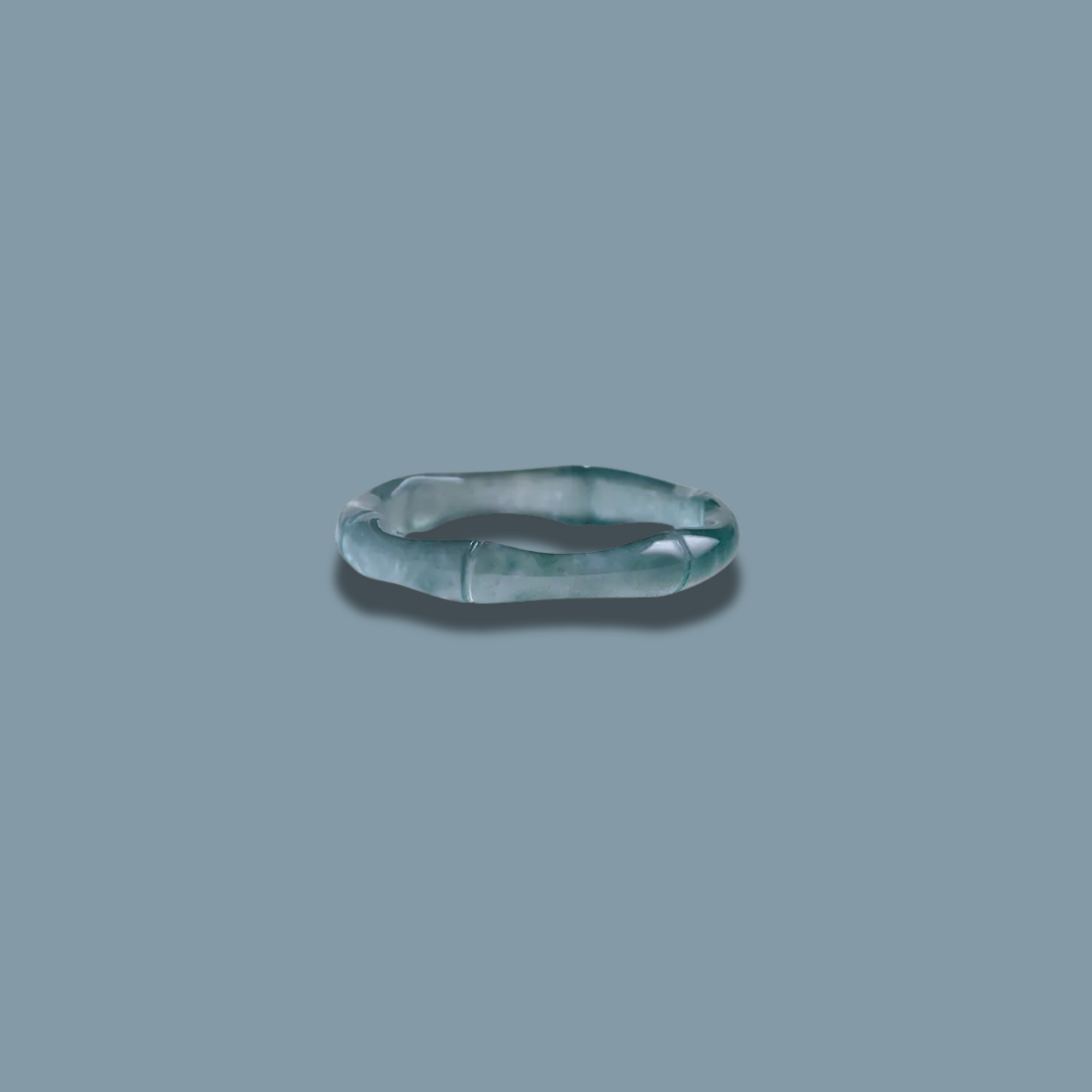 Close-up of the Lüwen Ring featuring intricately carved Jadeite with a textured surface.
