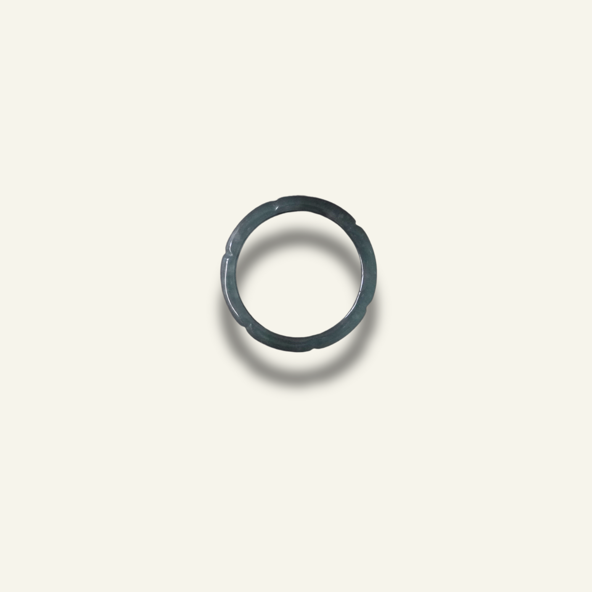 Carved Jadeite ring with rich texture and soft green hue, styled as a statement piece.
