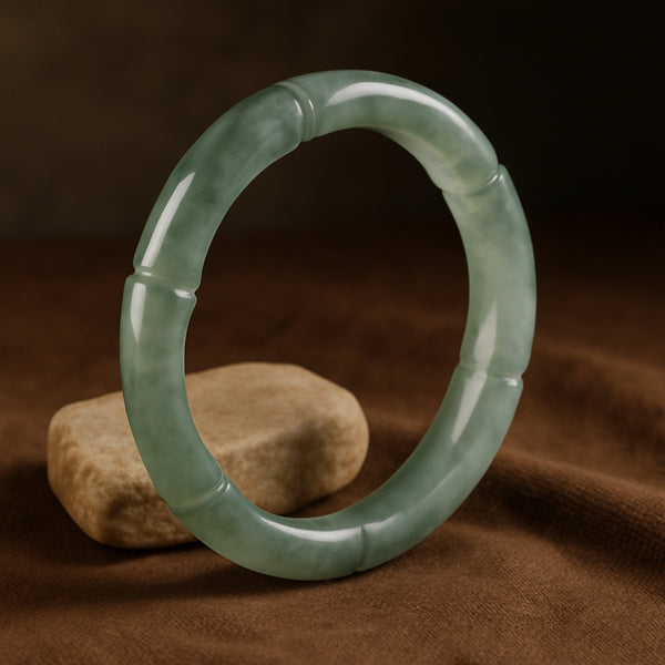Elegant green Jadeite ring with detailed carvings, displayed on a dark green background.