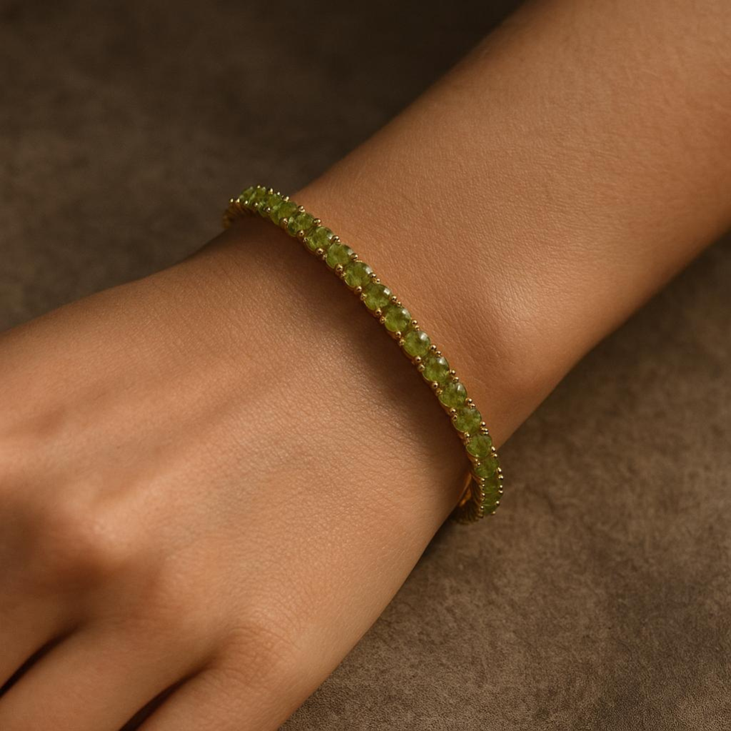 Green beaded bracelet on a wrist against a brown background