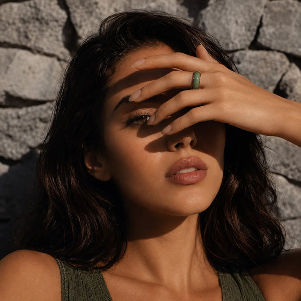Model covering face with jaura ring