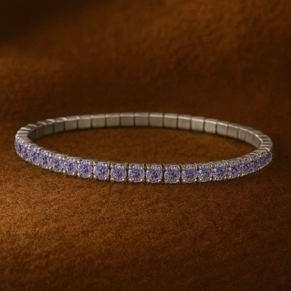Silver bracelet with purple stones on a brown textured background