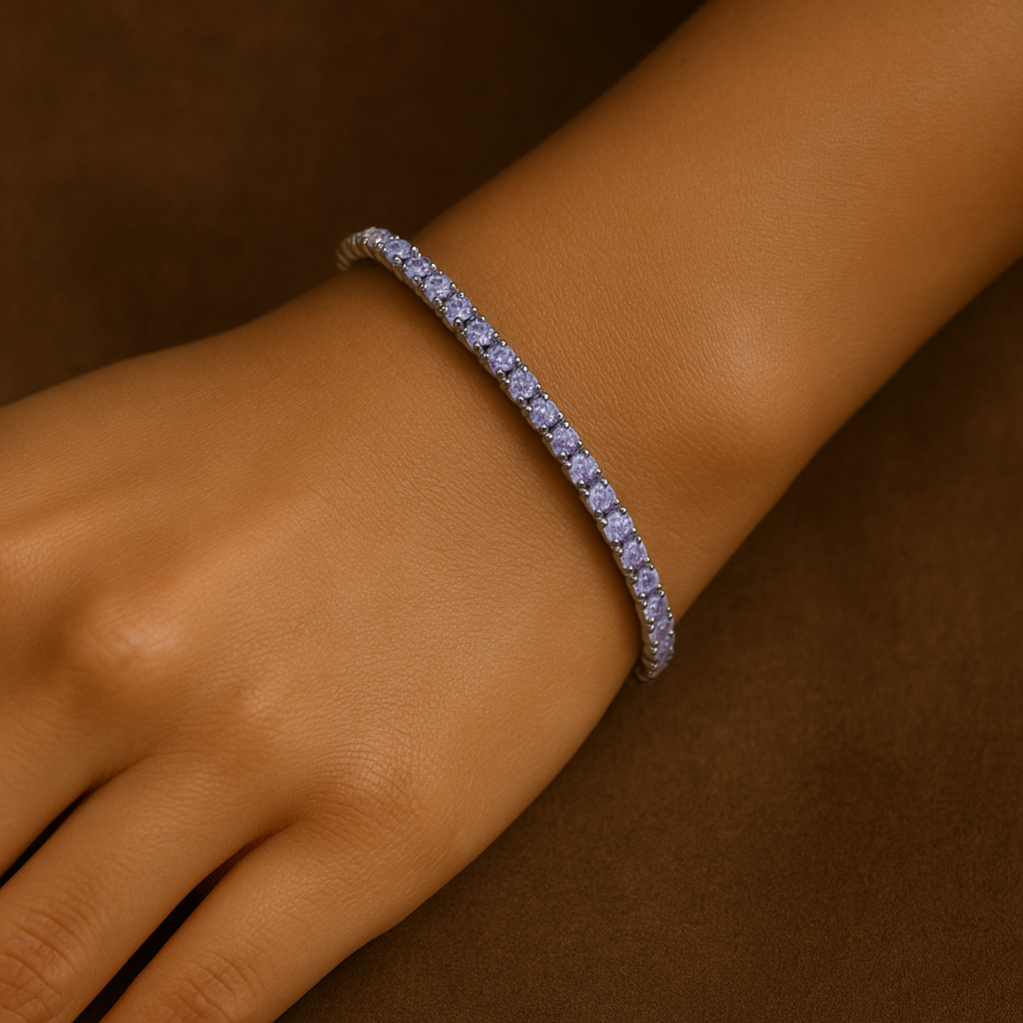 Silver bracelet with small stones on a wrist against a brown background