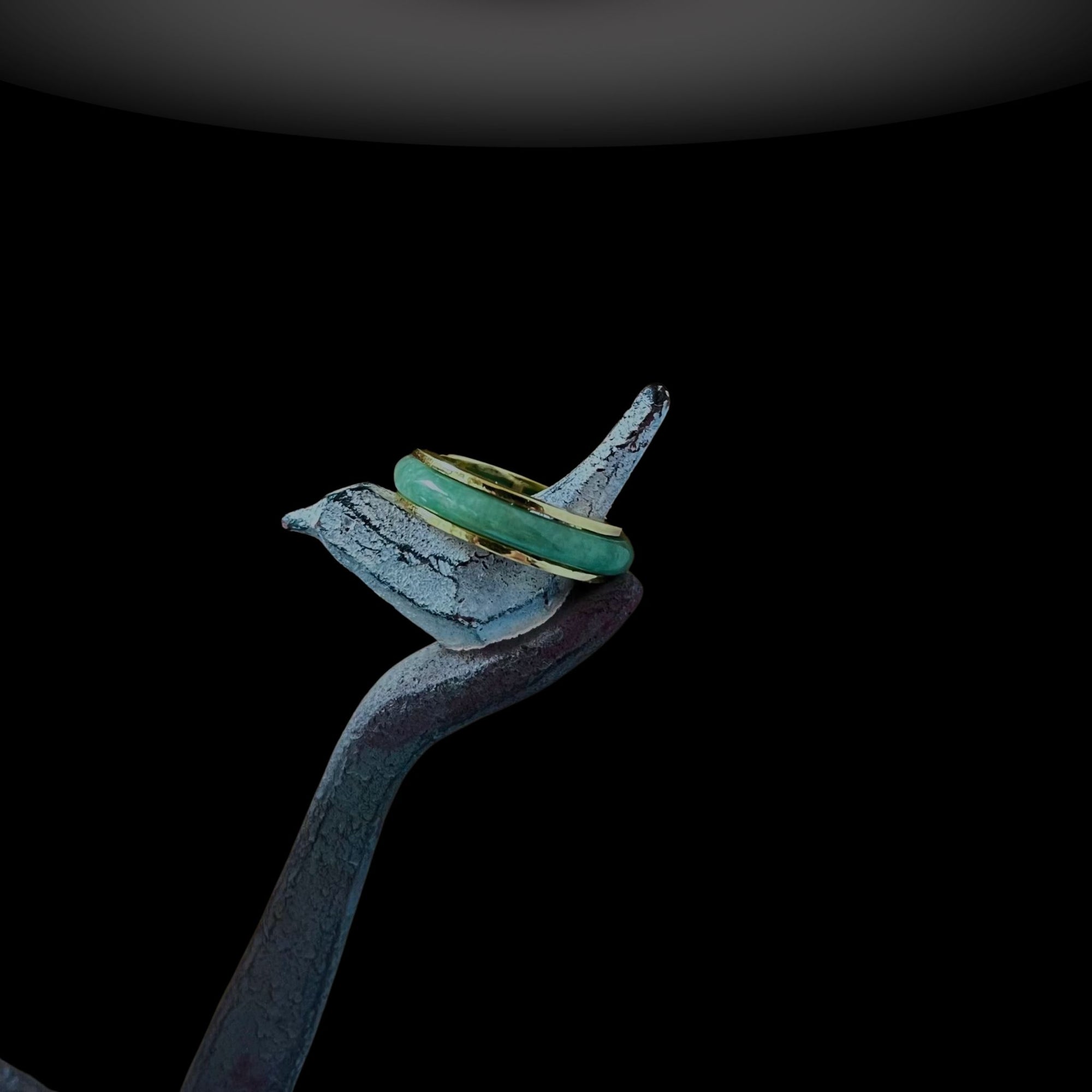 Side angle of the Jaura Ring showing thickness of gold band and setting of jadeite.