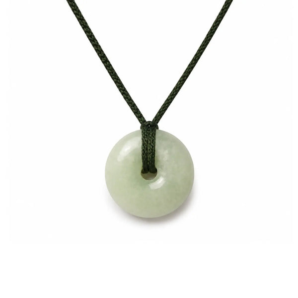 Necklace with a round, light green pendant jade on a white background