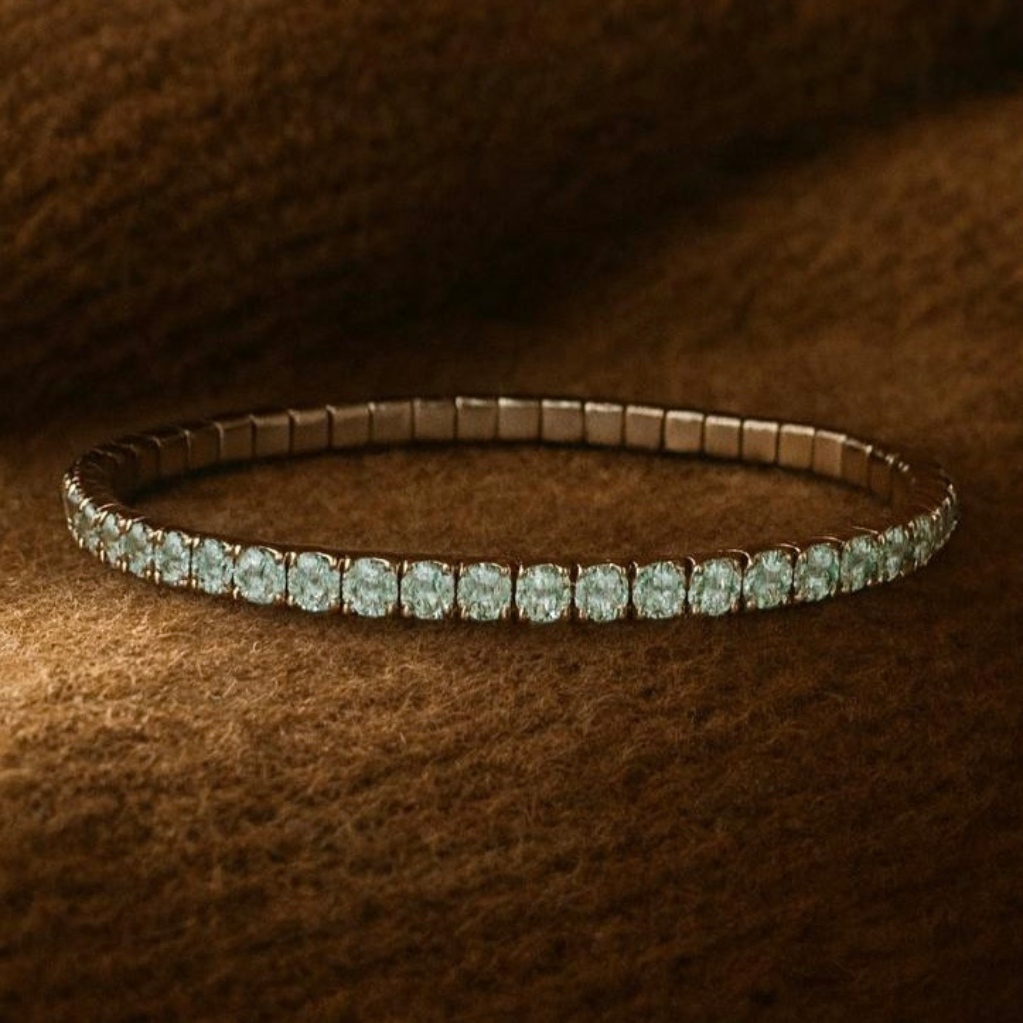 Silver bracelet with green gemstones on a brown textured background
