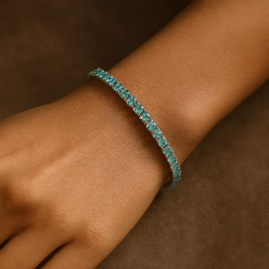 Turquoise bracelet on a wrist against a brown background