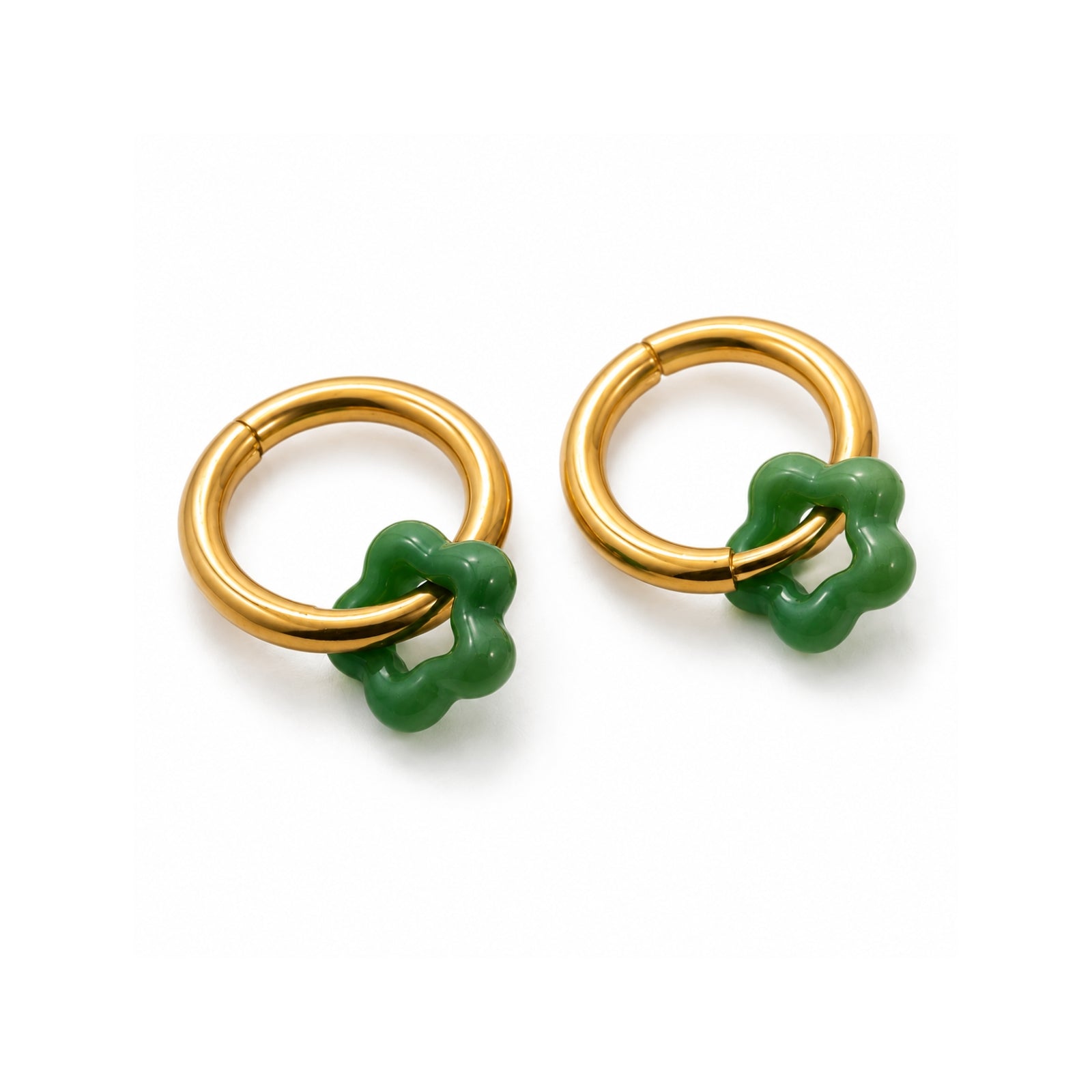Pair of gold hoop earrings with green accents on a white background