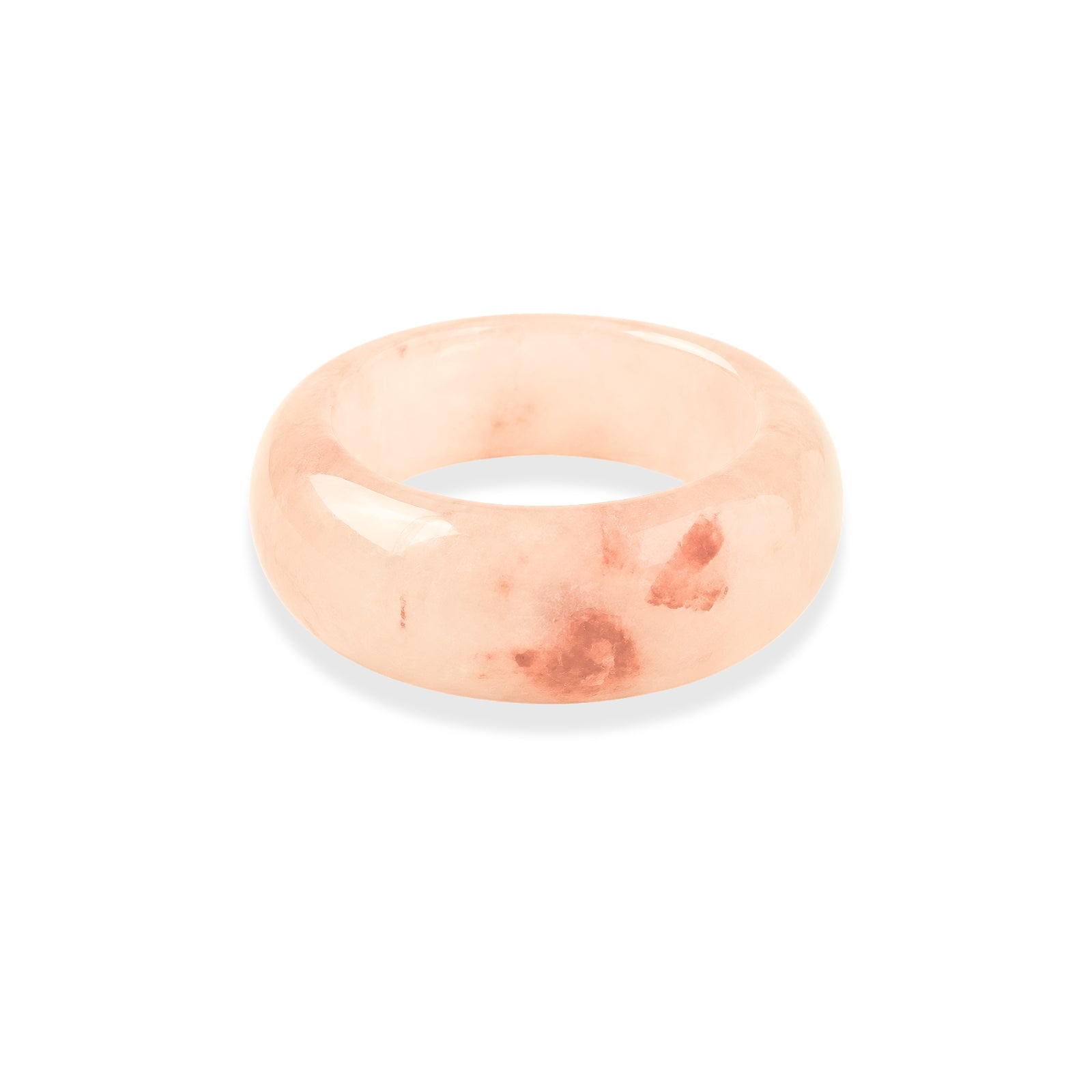 Pink stone ring with red inclusions on a white background