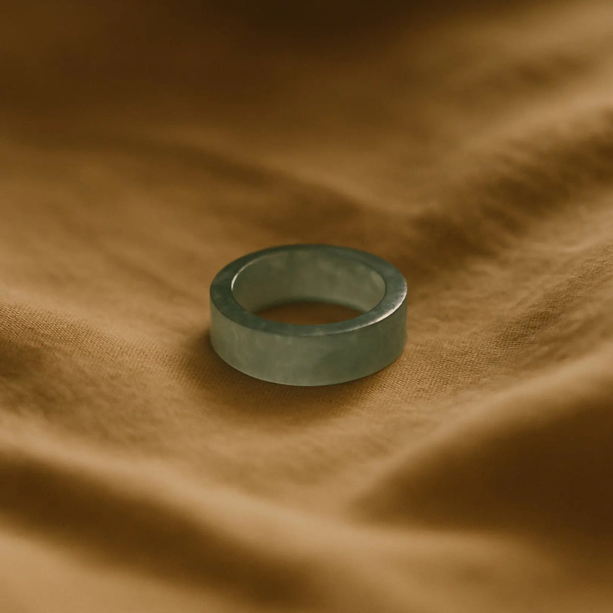 The Seren Jade Ring — a minimalist flat-profile band hand-carved from natural jadeite, showcasing smooth texture and modern elegance for daily wear or stacking.