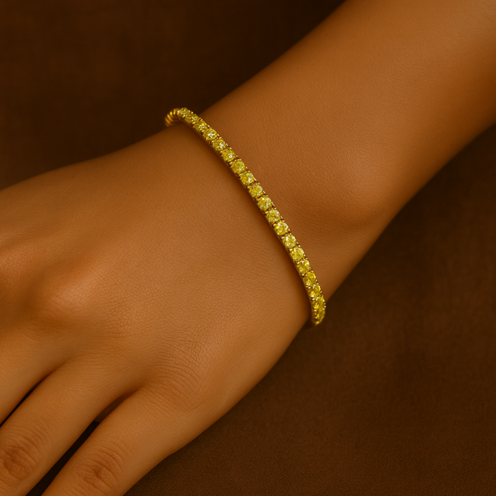 Gold bracelet on a wrist against a brown background