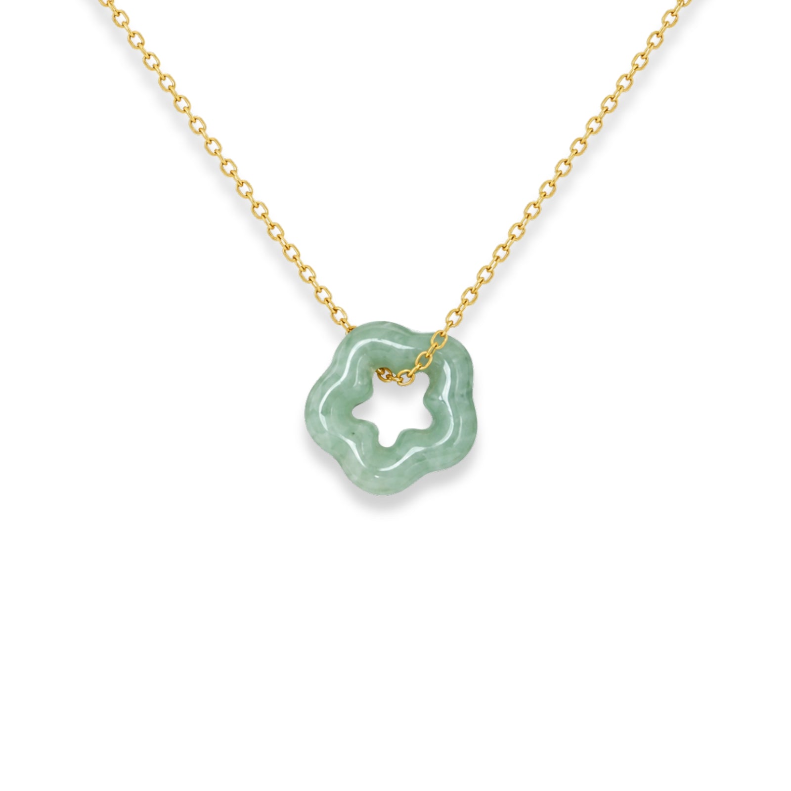 Necklace with a green pendant on a black card against a white fabric background